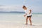 Boy with skim board on sea background