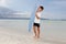 Boy with skim board on sea background