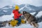 Boy sledding on winter mountain with husky dog, enjoying a sledge ride in a beautiful snowy winter park.