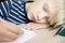 Boy sleeping while doing his homework in notebook.