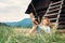 Boy sleeps in grass under hayloft in summer afternoon