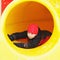 Boy sliding down in tube