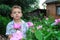 Boy smelling a peony.