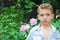 Boy smelling a peony.