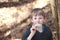 Boy smelling a scaly polypore