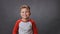 Boy smiles broadly in the studio against an isolated background. Child smiles in the studio. Mobile video. High quality