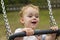 Boy smiling on swing