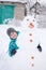 Boy and a snowman - winter holiday