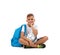 A boy with a soccer ball and a blue satchel sitting in a joga pose. Happy child isolated on a white background. Sports