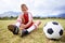 Boy, soccer player and ball with shoe laces, field and ready for game, shoes and child. Outdoor, playful and sport for