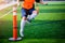 Boy soccer player perform coordination and strength drills by jumping over rope on on green artificial turf