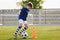 Boy in soccer uniform practice with ball. Child kicking ball on grass stadium. Young athlete improving football dribbling skills o