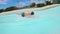 Boy speeding down sliding in a water slide at Water Amusement Park on summer