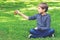 Boy with spinner sitting on the grass