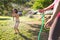 Boy splashed with water from a hose in the courtyard of the house on a hot sunny day