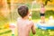 Boy splashing girl with water gun, garden swimming pool