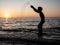 Boy splashing in sea with arms raised. Child play