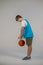 A boy in sporstwear with ball in hands