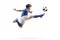 Boy in a sports jersey jumping and kicking a soccer ball