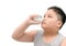 Boy spraying medicine in nose against flu or sinus