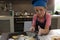 Boy sprinkling flour on cookies