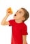 Boy squeeze orange to his mouth