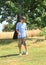 Boy standing above sprinkler