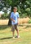 Boy standing above sprinkler