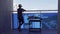 Boy standing on balcony, looking around, eating fresh cherry and enjoying sunny summer day