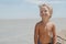 Boy standing on the beach in sunny day and laughing