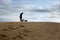 Boy Standing with Dogs On Dune