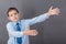 The boy standing near the blackboard