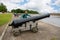 Boy standing near an old cannon in Kronstadt, Russia