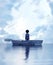 Boy standing on an old wooden rowboat