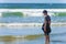 Boy standing in surf on Oregon Coast