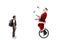 Boy standing and watching santa claus riding a mono cycle and juggling