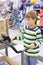 Boy stands on trainer treadmill in sports shop