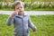 A boy on the street blows soap bubbles.