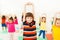 Boy stretching hands during sports lesson in gym