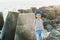 Boy in a striped T-shirt at the seaside breakwater