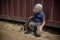 A boy stroking a street puppy - friendship between a child and a dog