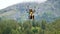 Boy study paragliding with instructor, flying with parachute high.