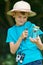 Boy Studying Butterfly Caught In Jar