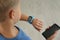 Boy with stylish smart watch and phone, closeup view