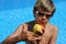 Boy with sun glasses presenting an apple