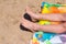 Boy sunbathing on the beach lying on the sand visible only feet sea sun beach vacation concept