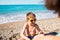 A boy in sunglasses plays on the beach