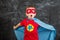 Boy superhero in a blue Cape red mask and a red t-shirt with a star
