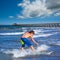 Boy surfer surfing waves on the Newport beach