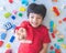 Boy surrounded by colorful toy blocks top view. showing I love you